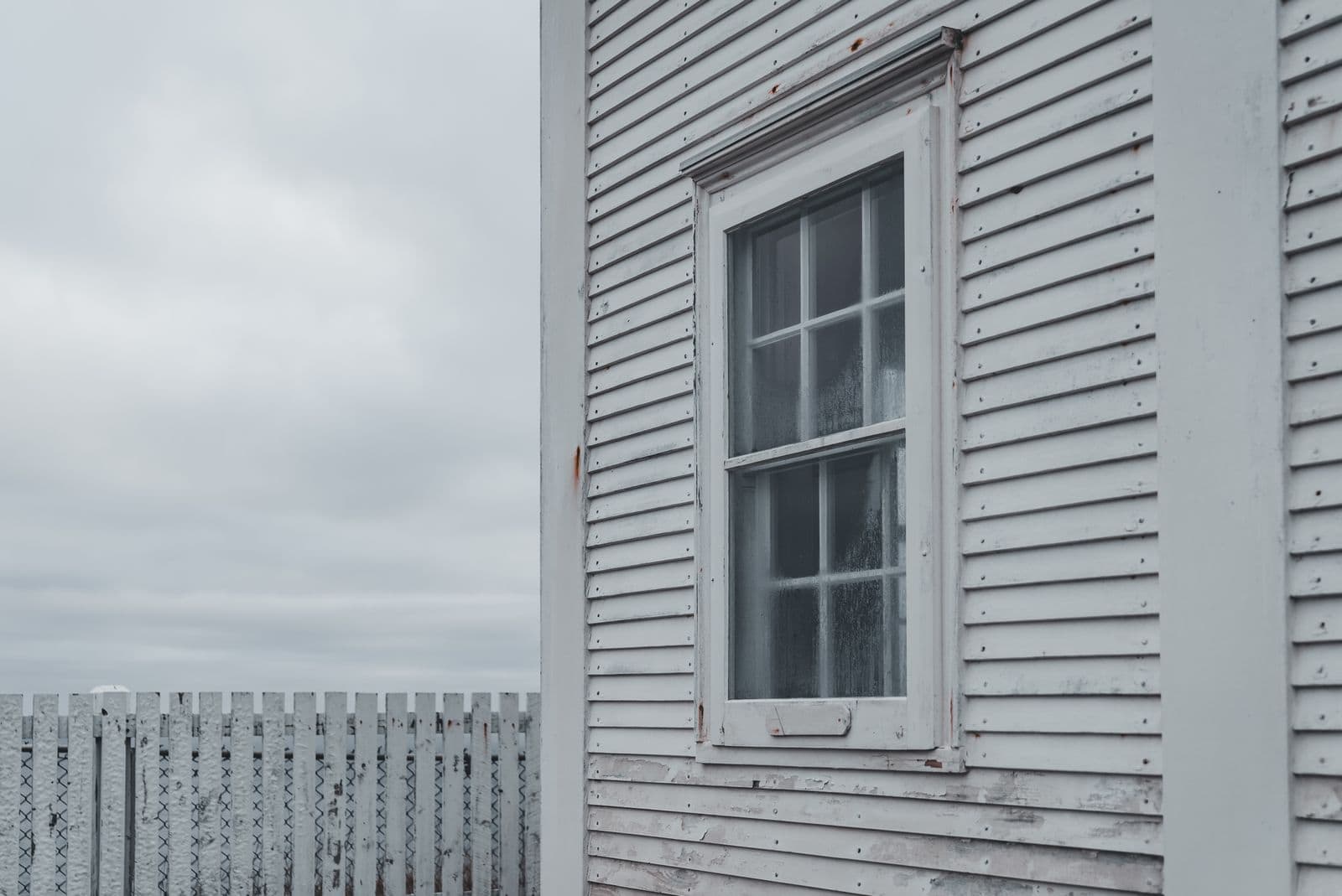 Gray painted lap siding around a window
